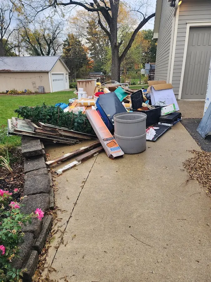 Dumpster being loaded with debris for 12 Yard Dumpster Rental in Vinton